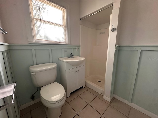 121 Bates Ave SE, Winter Haven, FL 33880 - bathroom featuring walk in shower, vanity, toilet, and tile patterned floors