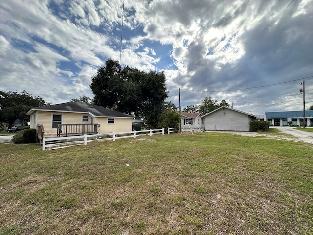 121 Bates Ave SE, Winter Haven, FL 33880 - view of side of property with a lawn and a wooden deck
