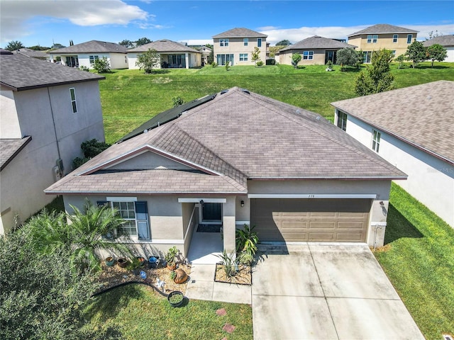 single story home featuring a garage and a front lawn