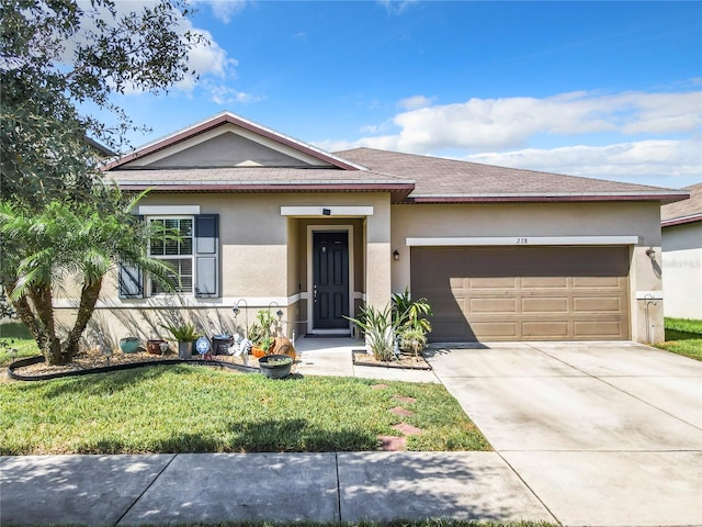 view of front of home featuring a garage and a front lawn