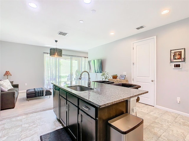 278 Alford Dr, Davenport, FL 33896 - kitchen featuring a sink, stainless steel dishwasher, light stone countertops, baseboards, and a kitchen island with sink
