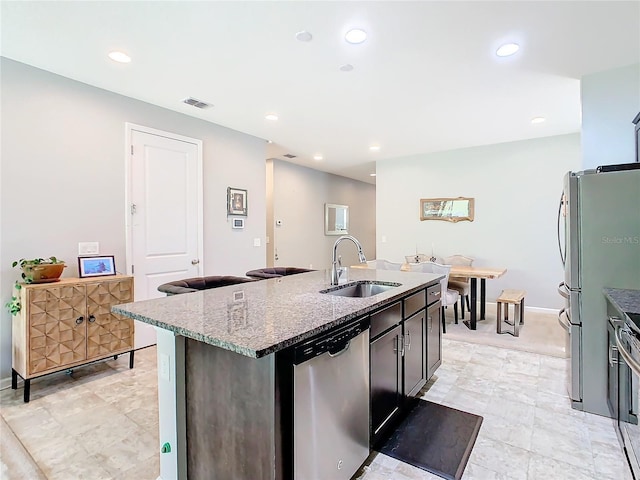 278 Alford Dr, Davenport, FL 33896 - kitchen with a sink, stainless steel appliances, a center island with sink, dark stone countertops, and recessed lighting