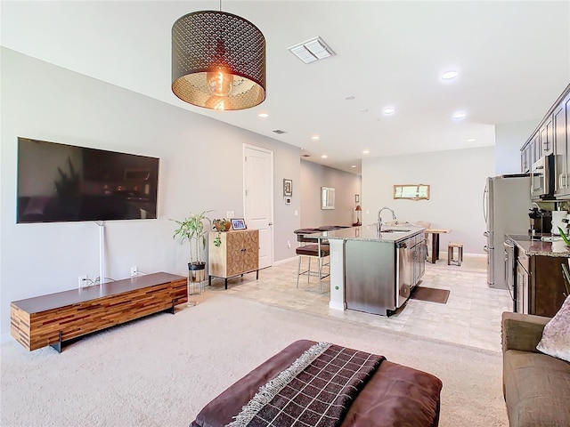 living room with sink and light colored carpet