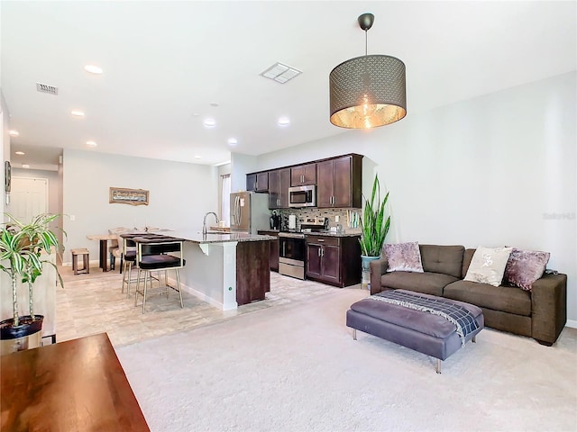 carpeted living room with sink