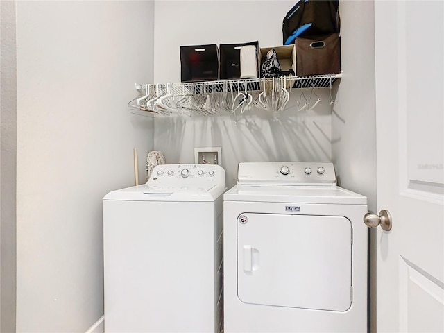 washroom with washer and dryer