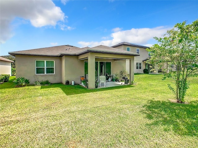278 Alford Dr, Davenport, FL 33896 - back of property with a patio, stucco siding, and a lawn