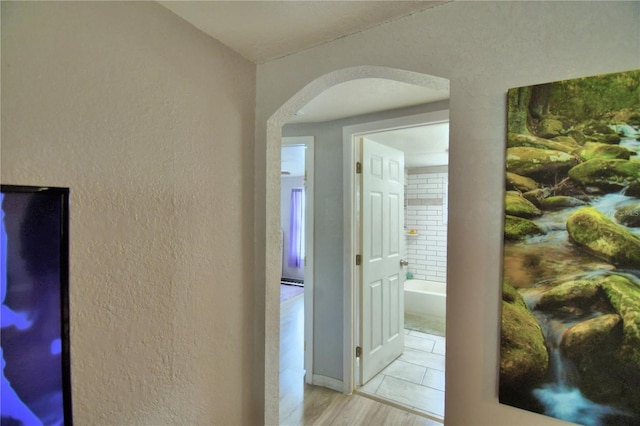 hall with light hardwood / wood-style flooring