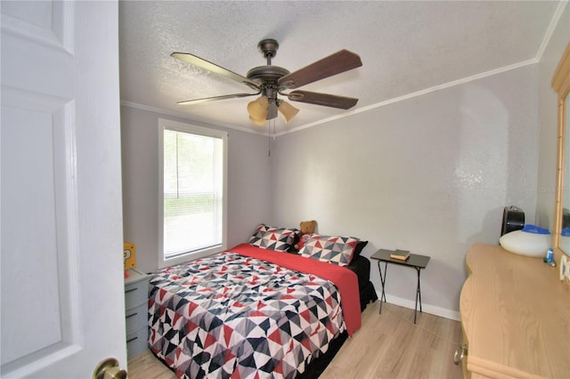 bedroom featuring ceiling fan, ornamental molding, a textured ceiling, and light hardwood / wood-style floors