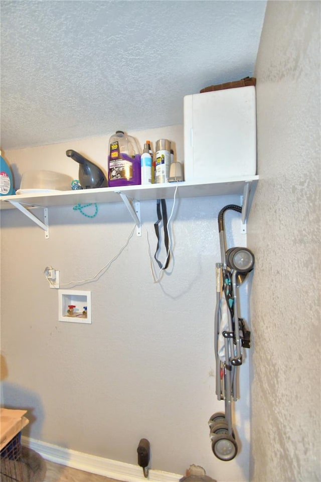 washroom featuring washer hookup and a textured ceiling