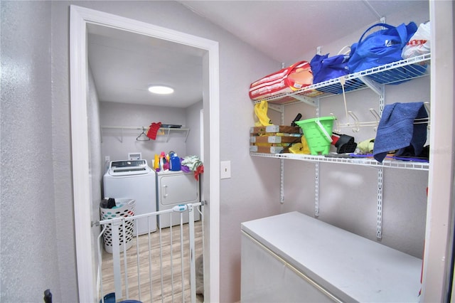 washroom featuring hardwood / wood-style flooring and washing machine and dryer