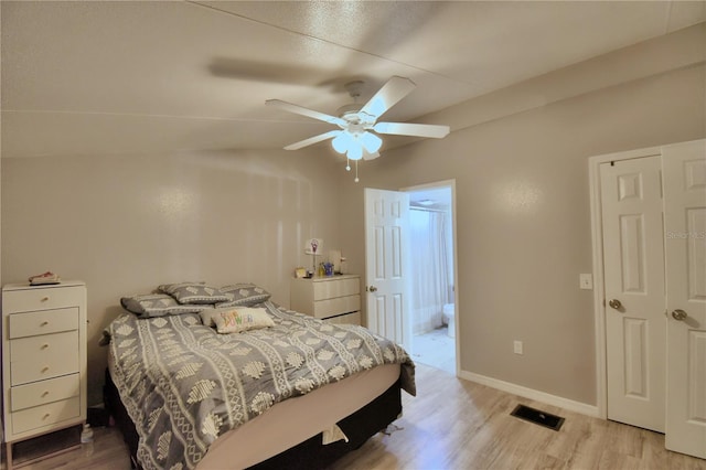 bedroom featuring ceiling fan, light wood-type flooring, and lofted ceiling