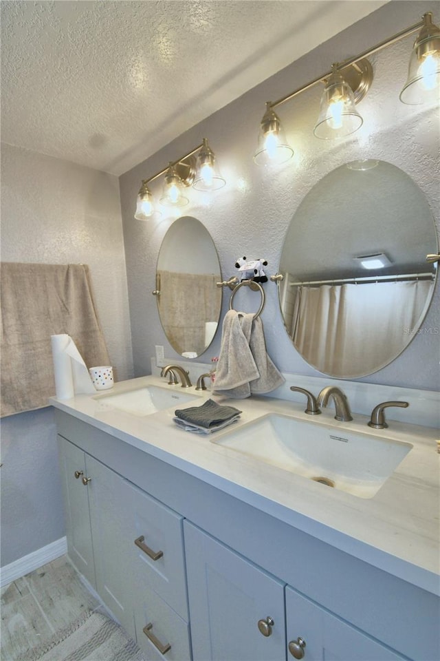 bathroom with a textured ceiling and vanity