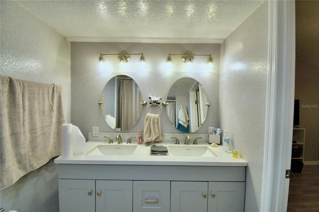 bathroom featuring vanity, hardwood / wood-style floors, and a textured ceiling