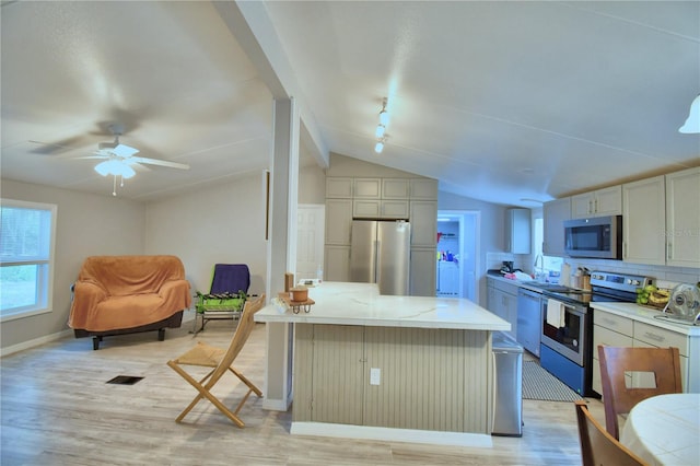 kitchen with light hardwood / wood-style floors, lofted ceiling, stainless steel appliances, backsplash, and ceiling fan