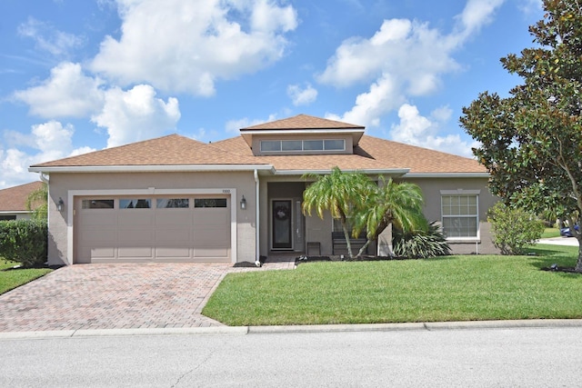 view of front of house featuring a garage and a front yard