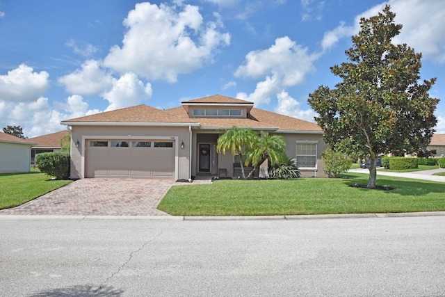 view of front of property with a front yard and a garage