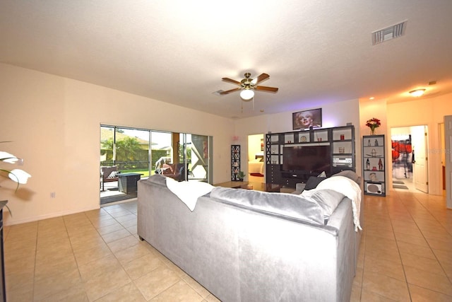 tiled living room with ceiling fan and a textured ceiling