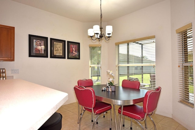 tiled dining room with an inviting chandelier