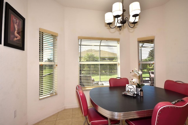 tiled dining room with a notable chandelier