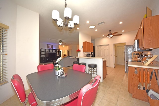 dining area featuring ceiling fan with notable chandelier and light tile patterned floors