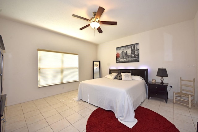 bedroom with ceiling fan and light tile patterned floors