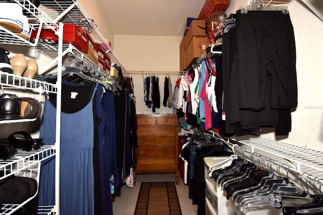 walk in closet with tile patterned floors