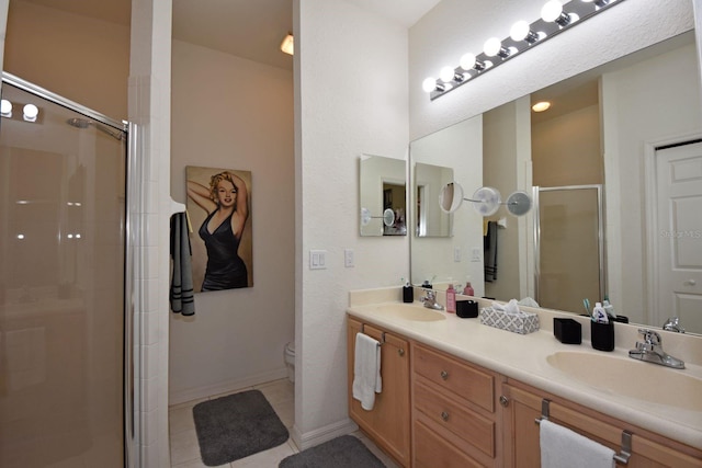 bathroom with vanity, a shower with shower door, toilet, and tile patterned flooring