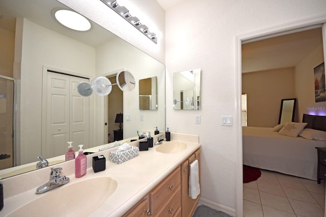 bathroom featuring tile patterned flooring, a shower with door, and vanity