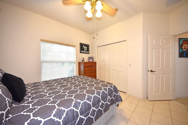 tiled bedroom with ceiling fan and a closet