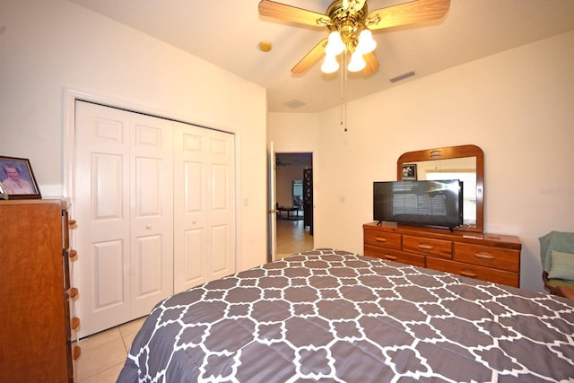 bedroom with a closet, ceiling fan, and light tile patterned flooring