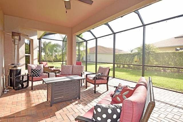 view of patio featuring ceiling fan, outdoor lounge area, and a lanai