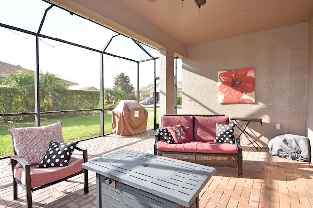 view of patio / terrace with glass enclosure, grilling area, and an outdoor living space