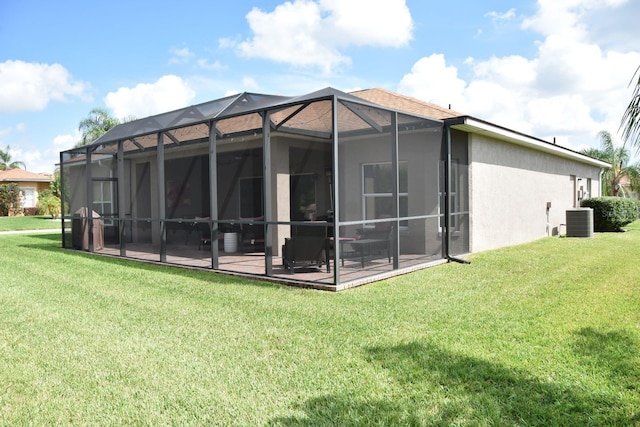 rear view of property featuring a yard, a lanai, central AC, and a patio area