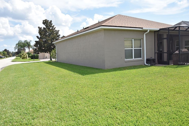 view of property exterior featuring a yard and a lanai