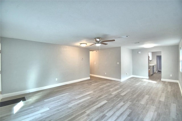 unfurnished room with ceiling fan and hardwood / wood-style flooring