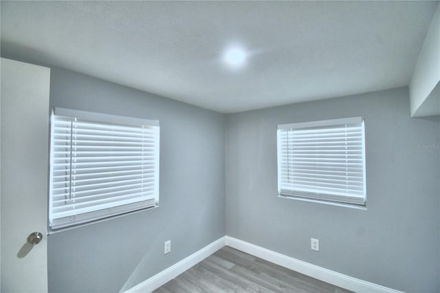 unfurnished room with wood-type flooring