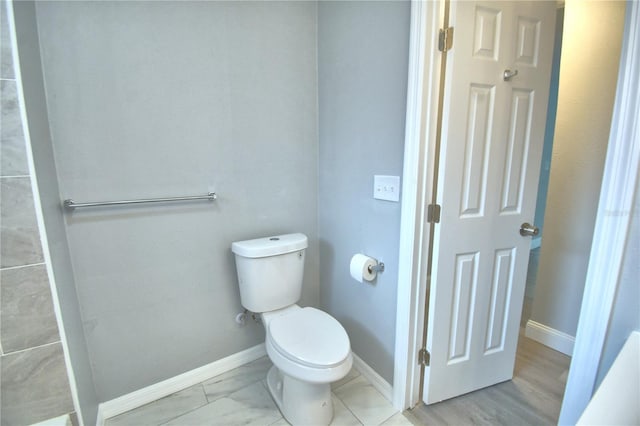 bathroom with hardwood / wood-style floors and toilet