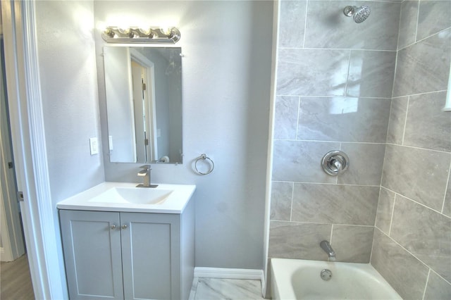 bathroom with vanity and tiled shower / bath