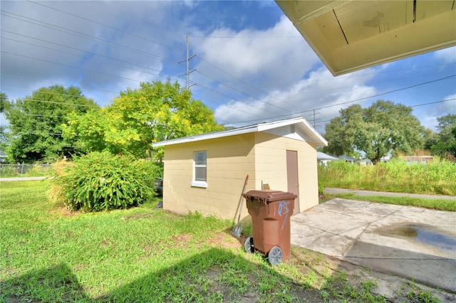 view of outbuilding featuring a yard