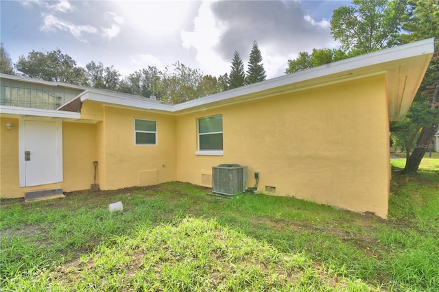 rear view of property featuring cooling unit