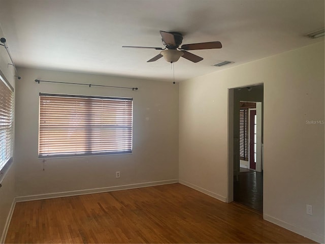 empty room featuring ceiling fan and hardwood / wood-style flooring