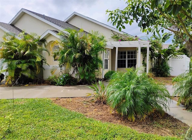 view of front of home featuring fence and stucco siding