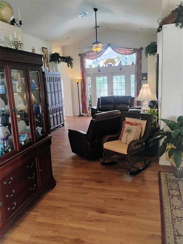 living room featuring ceiling fan and light hardwood / wood-style floors