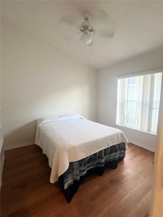 bedroom with wood-type flooring and ceiling fan