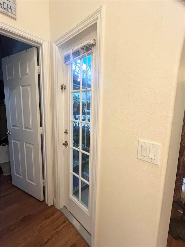 doorway with dark hardwood / wood-style floors