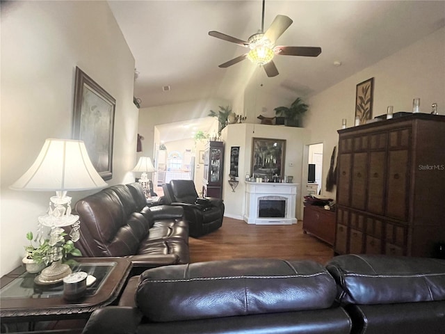 living room with hardwood / wood-style flooring, ceiling fan, and lofted ceiling