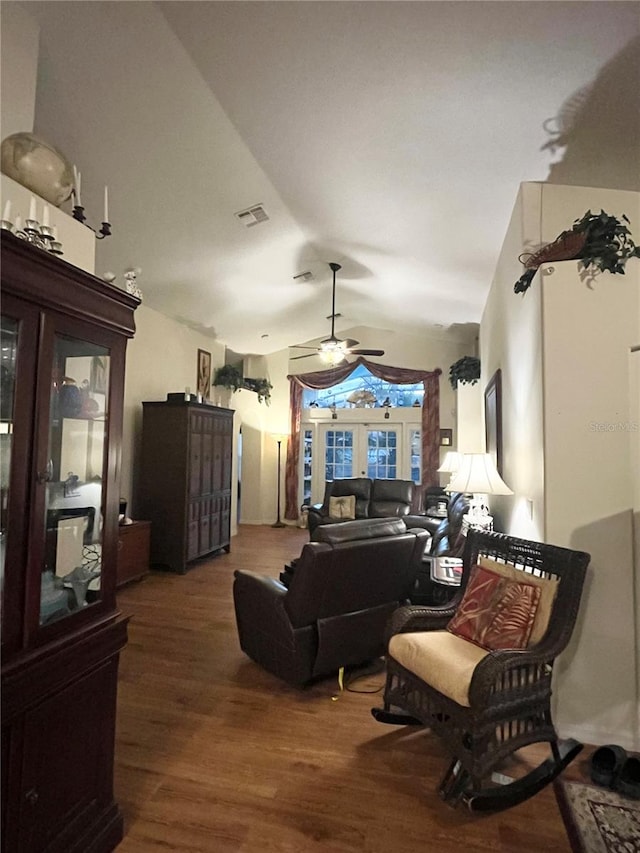 living room with hardwood / wood-style flooring, ceiling fan, and lofted ceiling