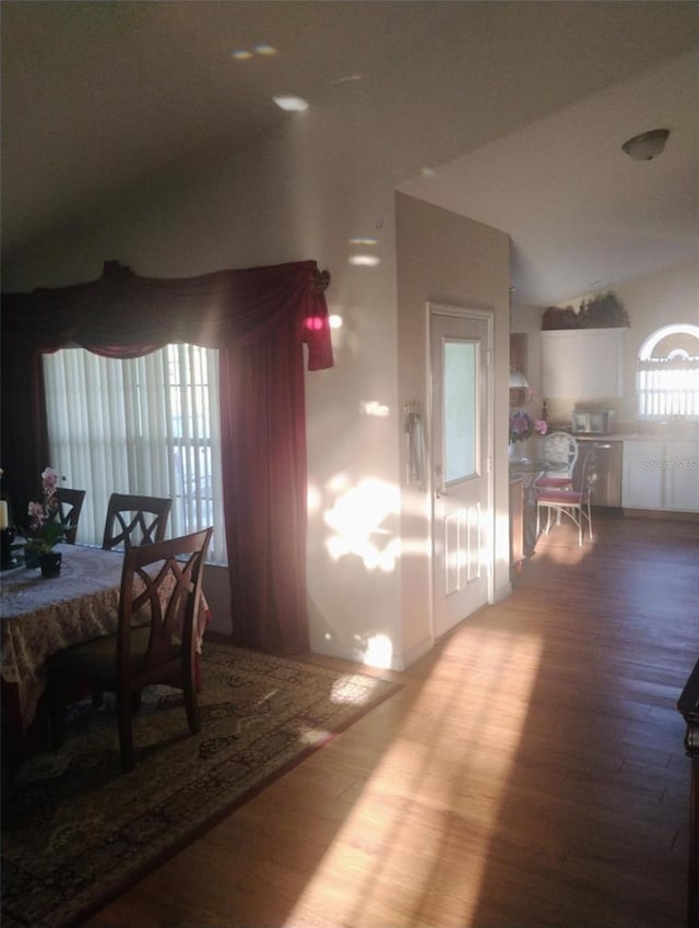 dining area with lofted ceiling and wood finished floors