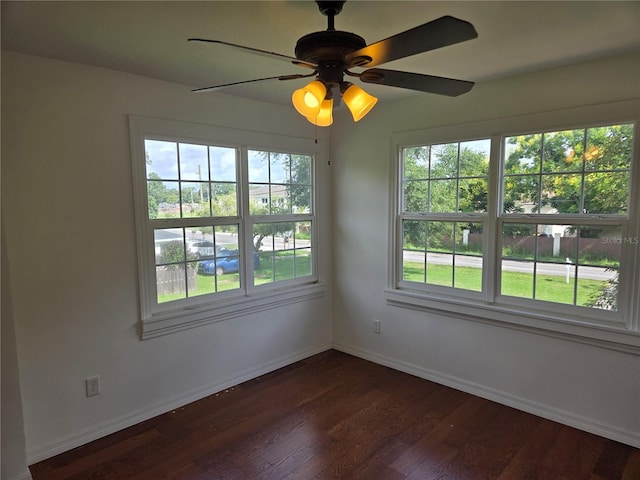 spare room featuring ceiling fan and dark hardwood / wood-style flooring