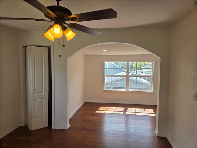 spare room featuring ceiling fan and dark hardwood / wood-style floors